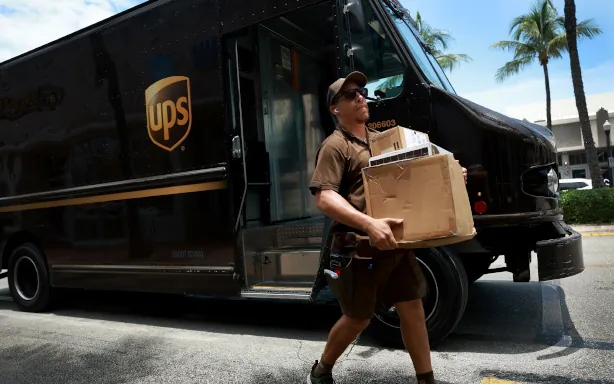 A UPS driver delivering a package